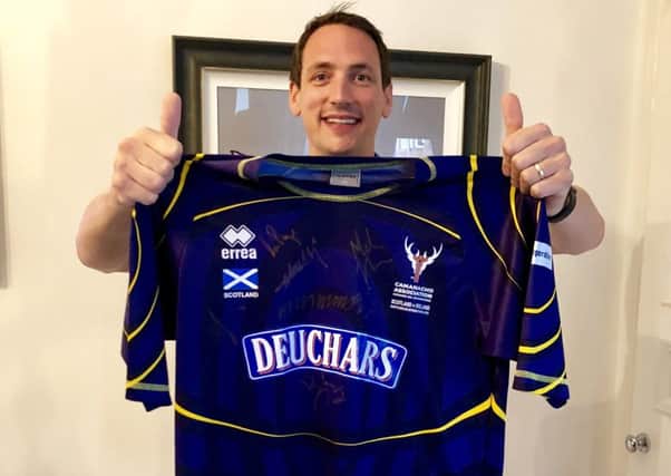 Gary Innes with the shirt, which raised Â£3,800 plus for youth shinty development.