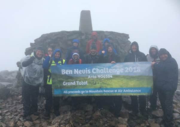Celebrating their success at the top of a misty Ben Nevis.