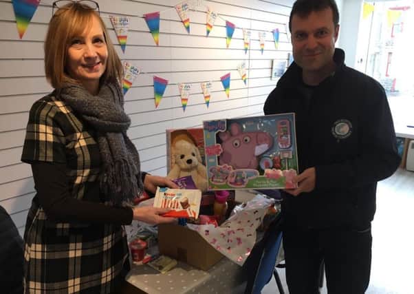 Pictured is Chrisetta Mitchell of The Leanne Fund with Paul Condy of The Scottish Salmon Company with a Pamper Hamper.