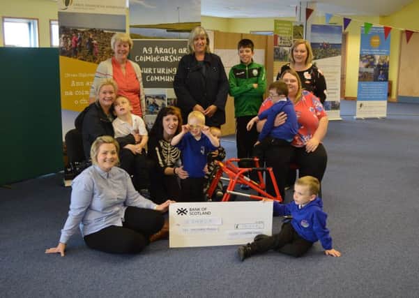Pictured are Agnes Rennie and Lisa Maclean (UOG) presenting a cheque for £10,000 to the Còmhla group.