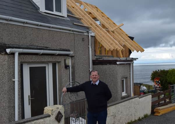 Murdo MacLeod outsite one of the properties which has been brought back to life and made a home once more.